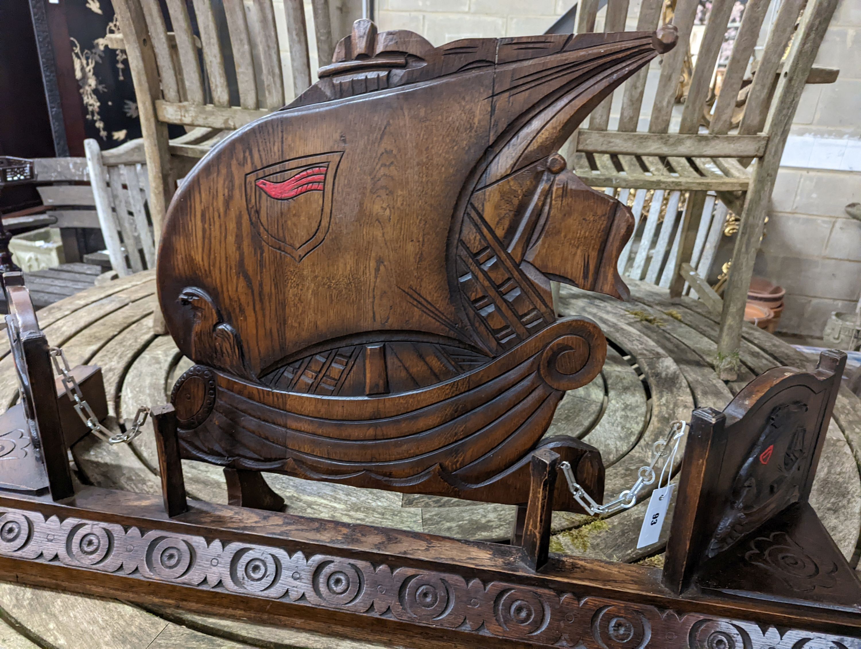 An early 20th century carved oak fender, length 124cm and a firescreen